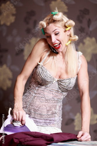 Photo: Housewife irons clothes and makeup corrects Housewife irons clothes and makeup corrects