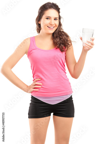 Photo: Sportswoman holding a glass of water Sportswoman holding a glass of water