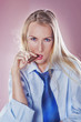 Photo: Cute woman smoking a cigar dressed with tie and shirt Cute woman smoking a cigar dressed with tie and shirt