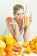 portrait of young woman with citrus fruit and orange juice