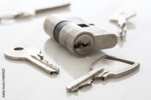 Photo: door lock with keys on white door lock with keys on white