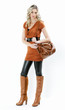 standing woman wearing fashionable brown boots with a handbag