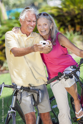 Photo: Senior Couple Bicycles Taking Digital Camera Picture Senior Couple Bicycles Taking Digital Camera Picture