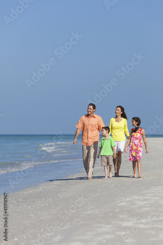 Photo: Mother, Father and Children Family Walking On Beach Mother, Father and Children Family Walking On Beach