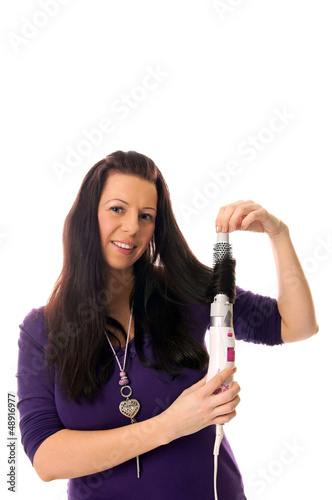 Photo: Woman with curling iron Woman with curling iron