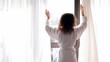 Woman comes to draws curtains and walks away, street traffic