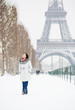 Photo: Winter in Paris. Happy young walking on Champ de Mars Winter in Paris. Happy young walking on Champ de Mars
