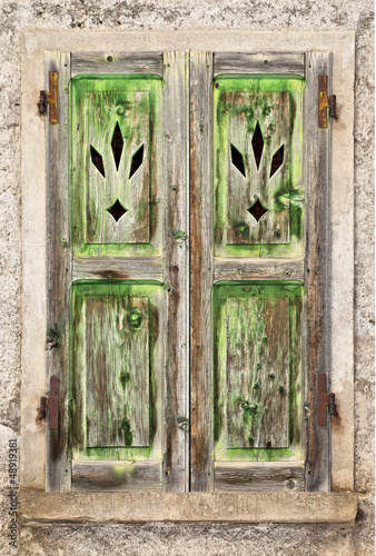 Photo: A Grungy old green wooden window A Grungy old green wooden window