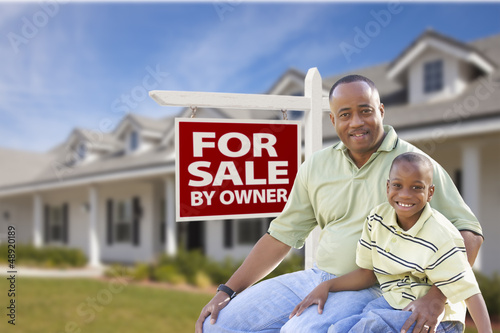 Photo: Father and Son In Front of For Sale By Owner Sign and House Father and Son In Front of For Sale By Owner Sign and House