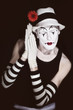 sleep mime in white hat with red flower on a black background