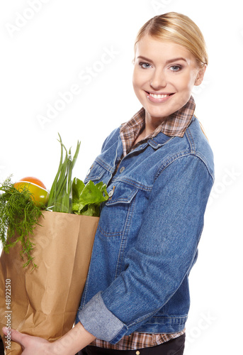 Photo: woman holding a bag full of healthy food. shopping . woman holding a bag full of healthy food. shopping .