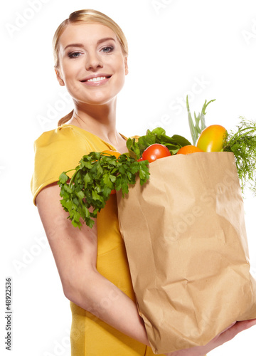 Photo: woman holding a bag full of healthy food. shopping . woman holding a bag full of healthy food. shopping .