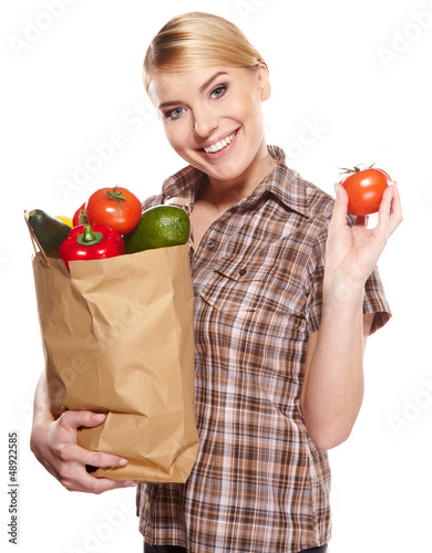 Photo: woman holding a bag full of healthy food. shopping . woman holding a bag full of healthy food. shopping .