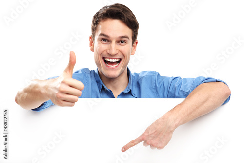 Photo: Man showing thumbs up with blank board Man showing thumbs up with blank board