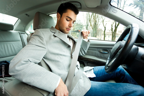 Photo: Man fastening his safety belt Man fastening his safety belt