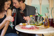 Young couple in restaurant, soft focus on glass