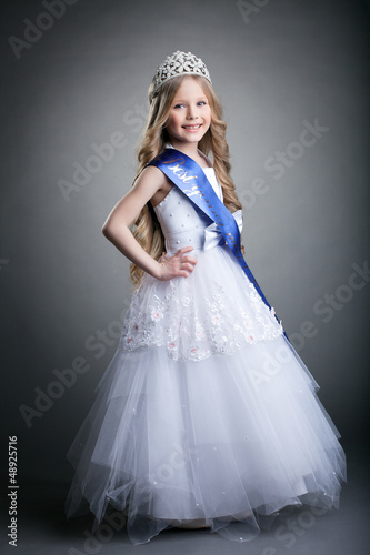 Photo: Pretty little girl in tiara and long white dress Pretty little girl in tiara and long white dress