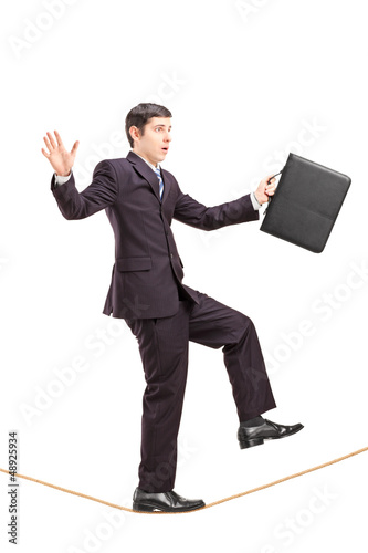 Photo: Full length portrait of a businessman with briefcase walking on Full length portrait of a businessman with briefcase walking on