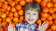 Happy girl lying in orange. Looking at the camera