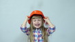 Orange rain. Girl in the construction helmet. Falling tangerines