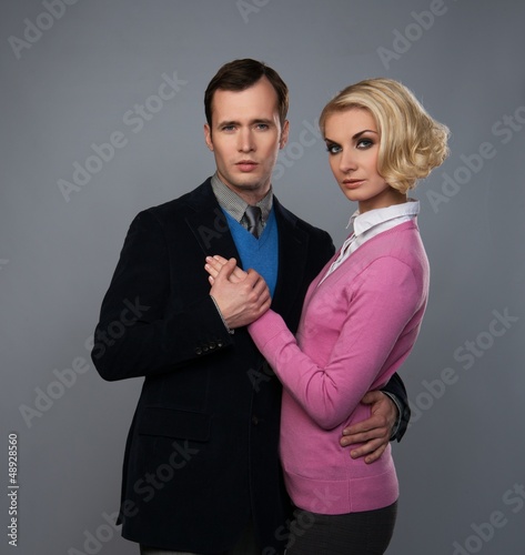 Photo: Elegant couple isolated on grey background Elegant couple isolated on grey background