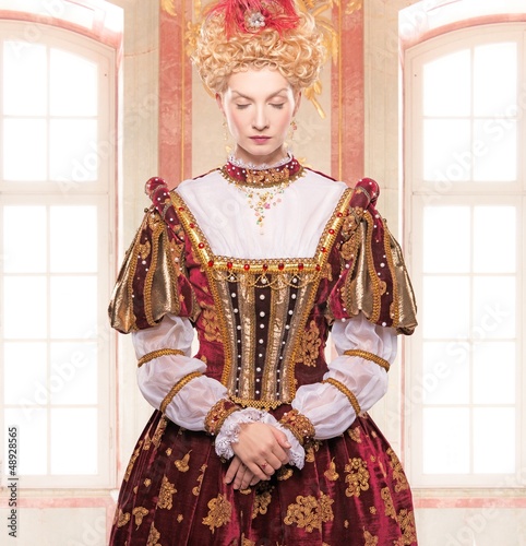 Photo: Her royal highness standing against window Her royal highness standing against window