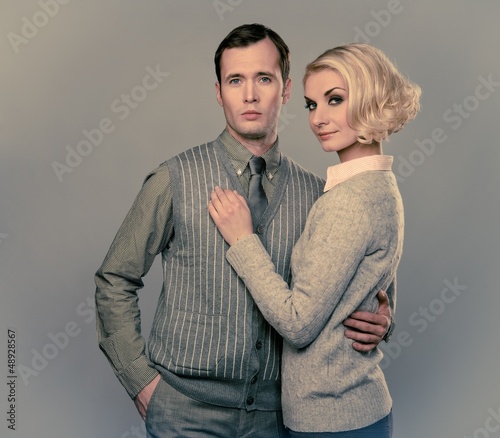 Photo: Elegant couple isolated on grey background Elegant couple isolated on grey background