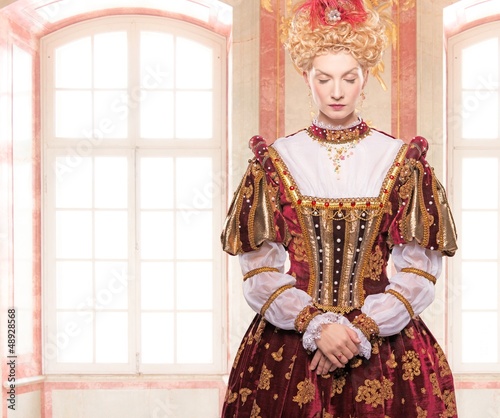 Photo: Her royal highness standing against window Her royal highness standing against window