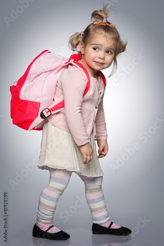 Photo: Funny little girl with backpack Funny little girl with backpack