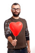 Photo: Handsome young man with beard holding red balloon Handsome young man with beard holding red balloon