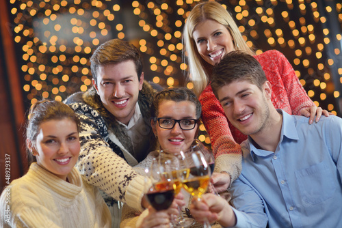 Photo: Group of happy young people drink wine at party Group of happy young people drink wine at party