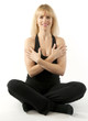 Mature, pretty  blond woman doing yoga stretching exercise
