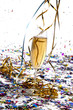 Glass of champagne with streamers and confetti