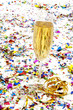 Glass of champagne with streamers and confetti