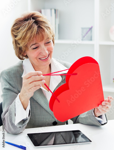 Photo: Businesswoman with red heart present Businesswoman with red heart present