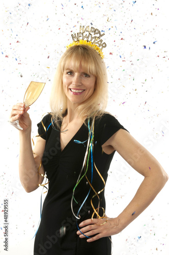 Photo: Woman celebrating with a glass of champagne on New Year's Eve Woman celebrating with a glass of champagne on New Year's Eve