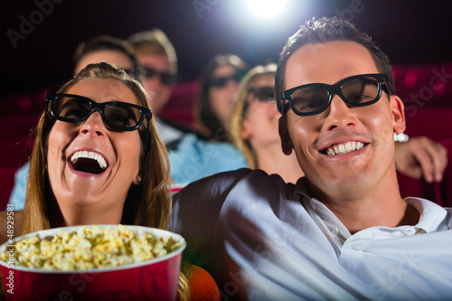 Photo: Young people watching 3d movie at movie theater Young people watching 3d movie at movie theater