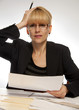 Stressed female executive office hand on head