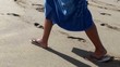 Detail of boy legs walking on the beach