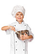 Happy little Chef girl with ladle girl having fun making cookies