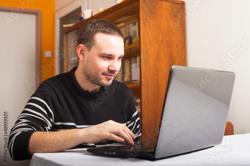 Photo: Smiling man with laptop Smiling man with laptop