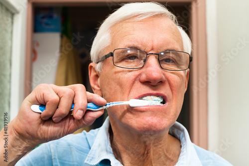 Photo: Senior man brushing his teeth Senior man brushing his teeth