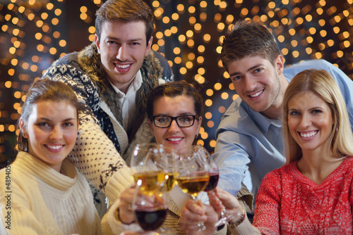 Photo: Group of happy young people drink wine at party Group of happy young people drink wine at party