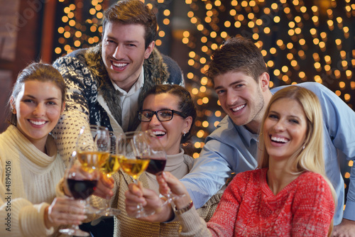 Photo: Group of happy young people drink wine at party Group of happy young people drink wine at party