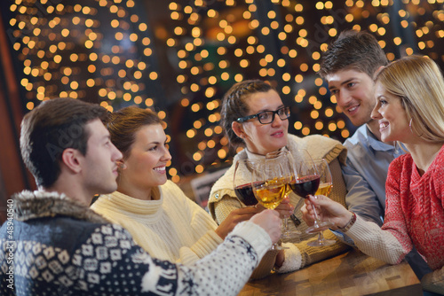 Photo: Group of happy young people drink wine at party Group of happy young people drink wine at party