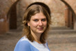 Portrait of a woman against a brick arch
