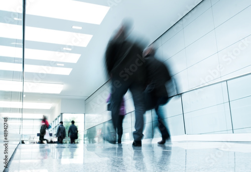 Photo: futuristic indoor walkway with blurred people futuristic indoor walkway with blurred people