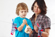 Little boy helps her mother to hang up your toy and socks