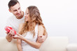 man giving heart-shaped box  for his girlfriend