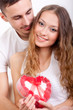 man giving heart-shaped box  for his girlfriend